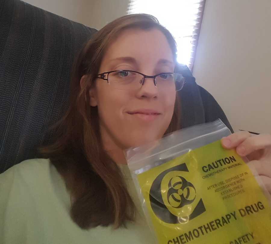 Mother with breast cancer holds up hazardous bag labeled, "chemotherapy drug" in selfie