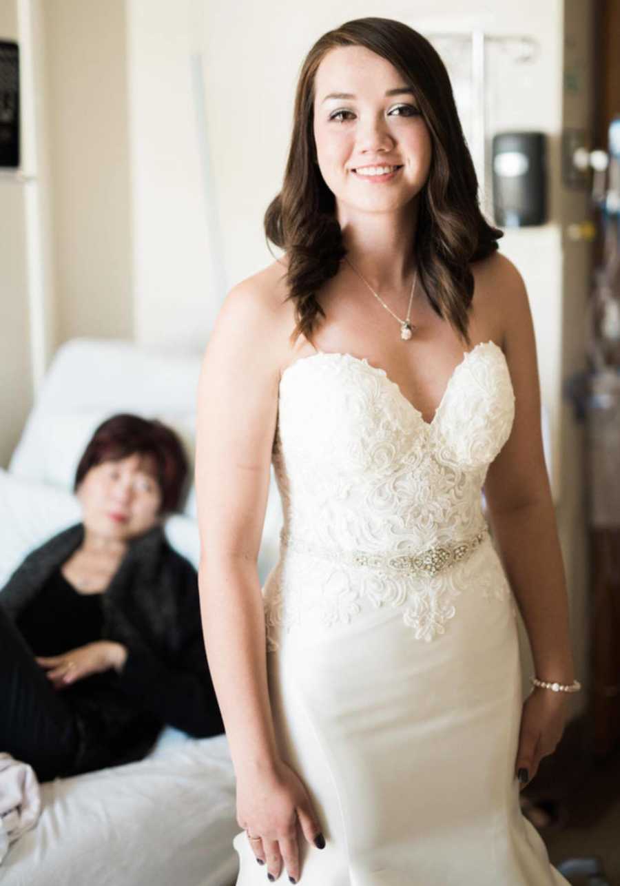 Daughter in wedding gown stands in front of terminally ill mother who will never see her daughter marry