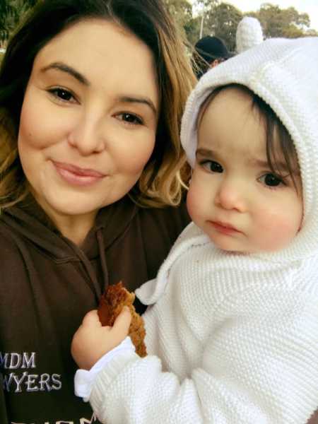 Mother who urges mothers to be kind to each other smiles while holding daughter in selfie