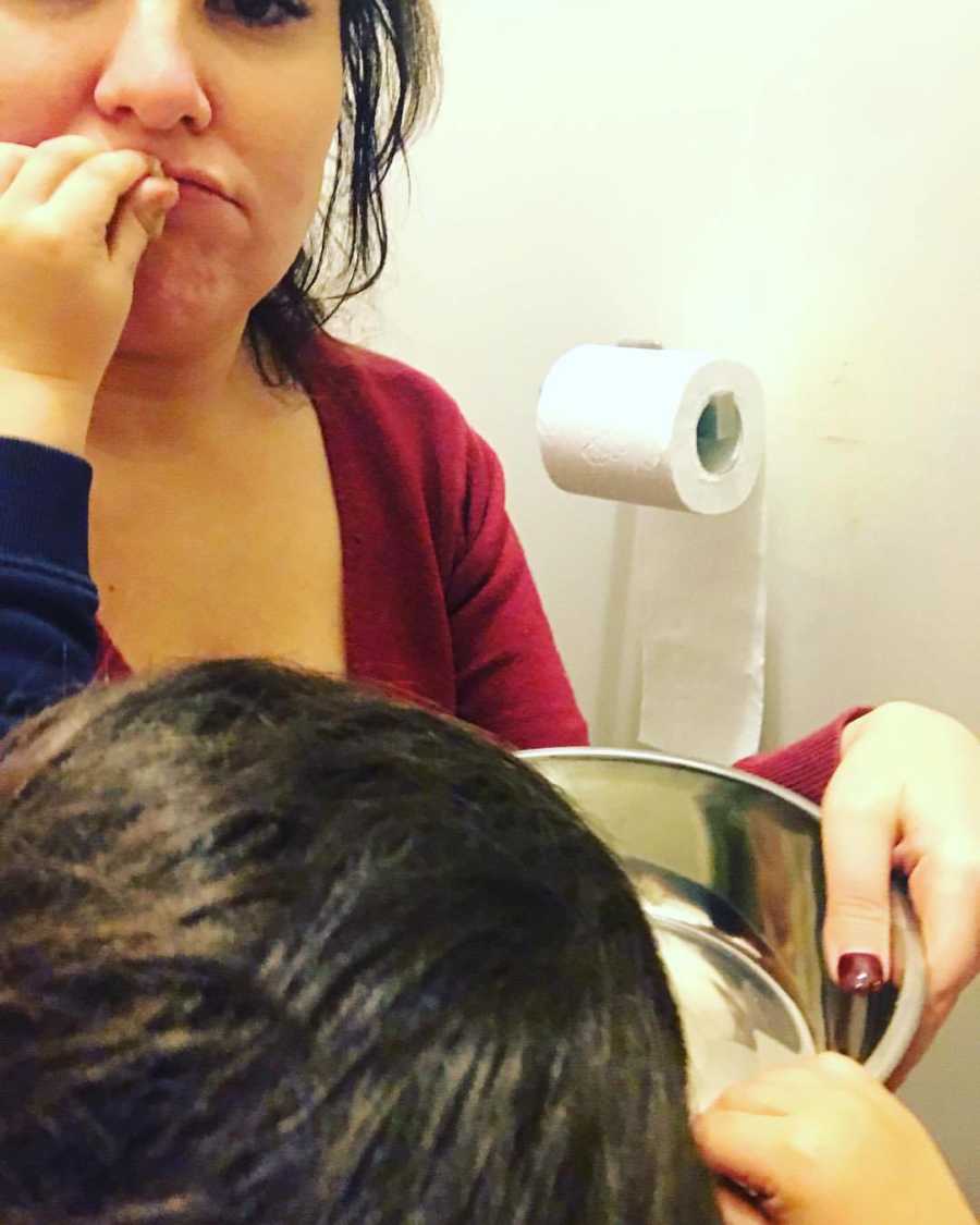 Mother who says motherhood takes it out of her takes selfie while she holds bucket for child to throw up in