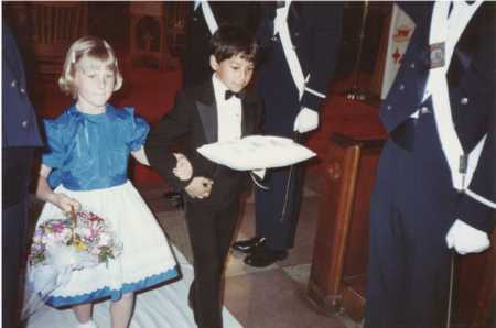 Children walking down aisle wearing clothes older woman sewed for them