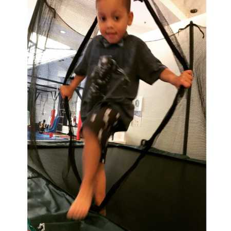 Autistic boy walking out of netting of trampoline