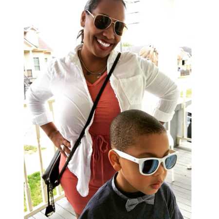 Woman with sunglasses on and hands on her hip stands behind autistic nephew