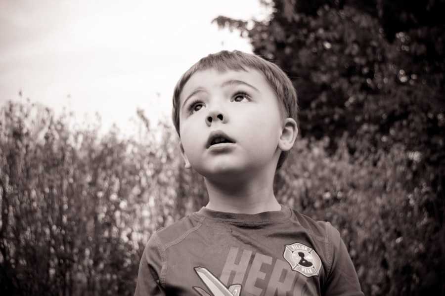 Close up of boy with autism looking up to sky