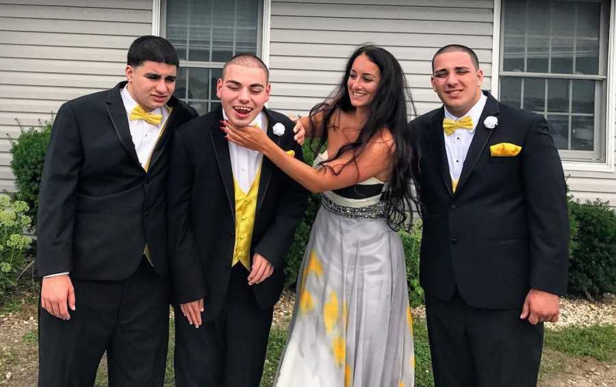 Woman smiles with three brothers with autism who she says gave her advantage in life