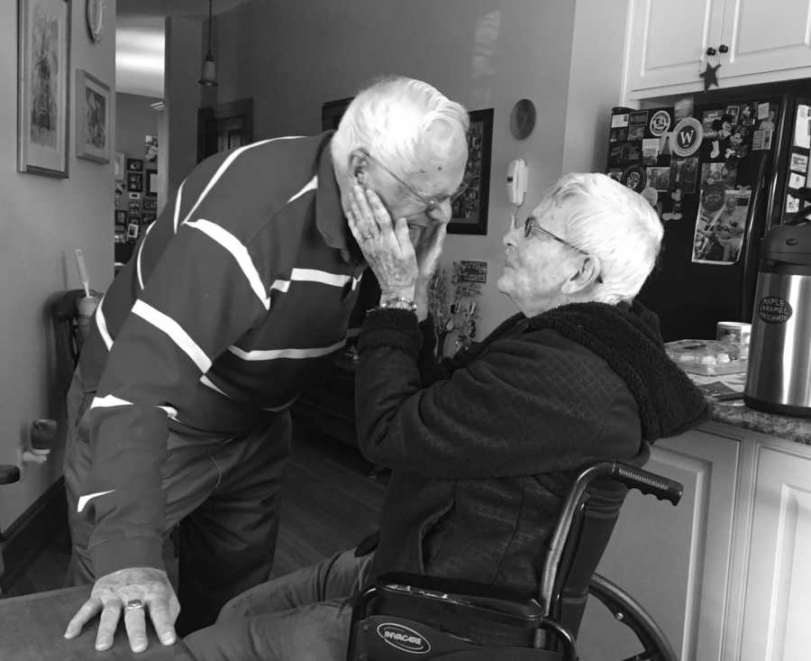 Woman who raised her kids to have manners sits in wheelchair in home holding husband's face