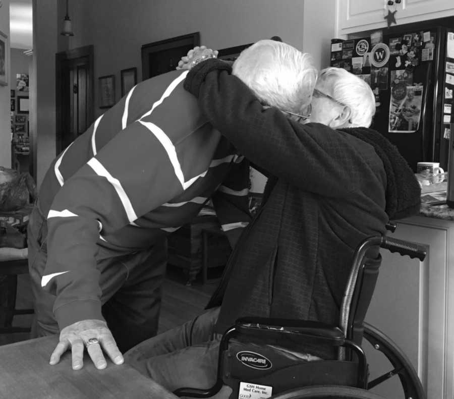 Mother who raised her kids to have manners sits in wheelchair kissing husband with arms wrapped around him