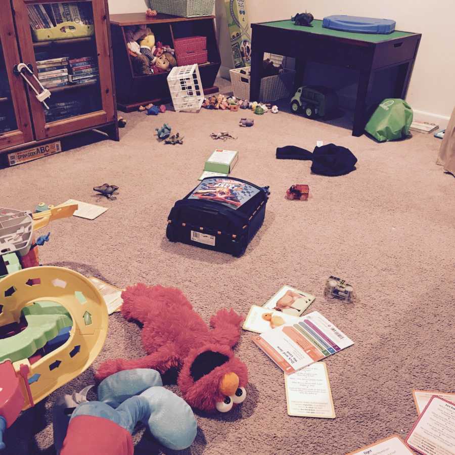 Playroom with toys covering the floor in women's house who feels like she is failing at everything