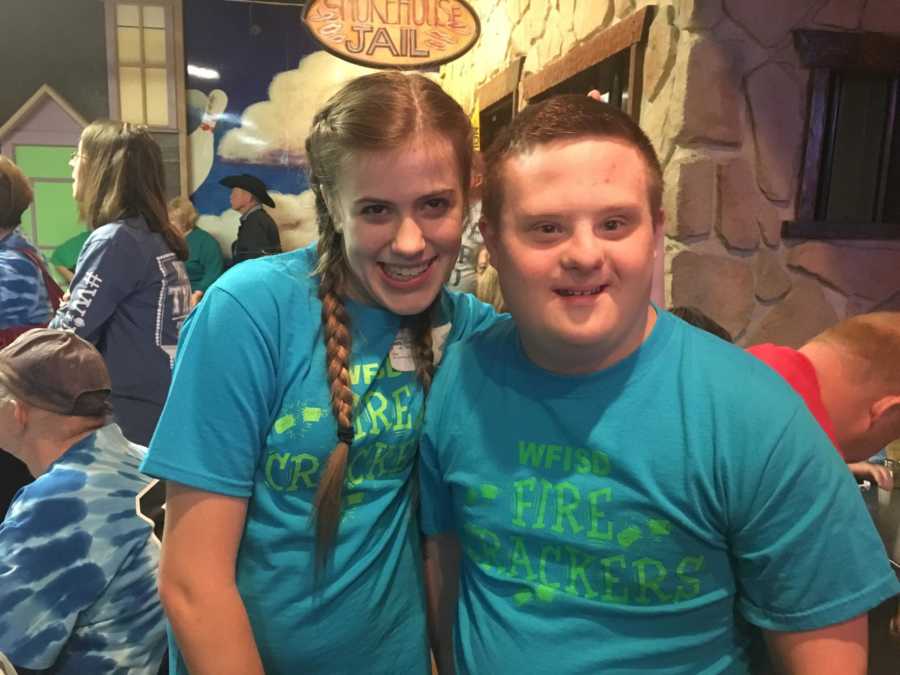 Boy and girl with special needs smiling in matching tshirts