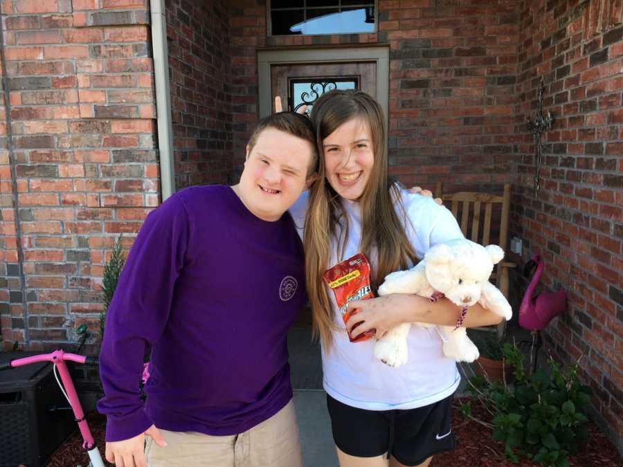 Boy and girl with special needs smiling after he asked her to prom