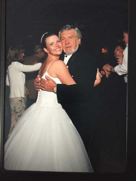 Bride hugging grandfather who was her father figure at wedding reception