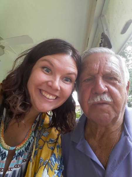 Woman smiles in selfie with grandfather who raised her