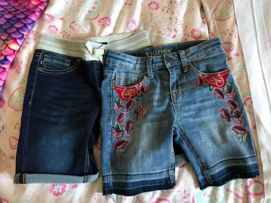 Long jean shorts lying on bed that mother and daughter fought over due to length
