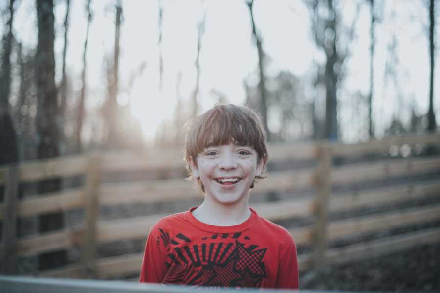 Young boy who was put up for adoption smiling