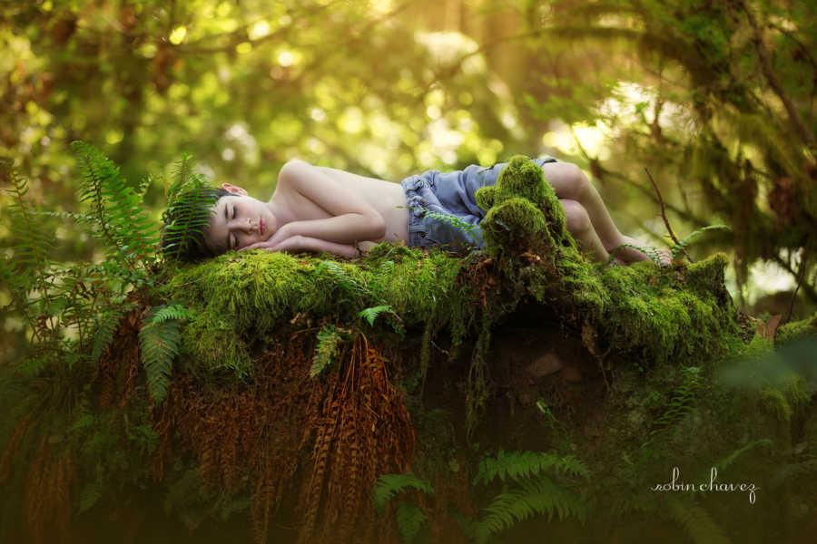 Son of man who died lays on mossy plant 
