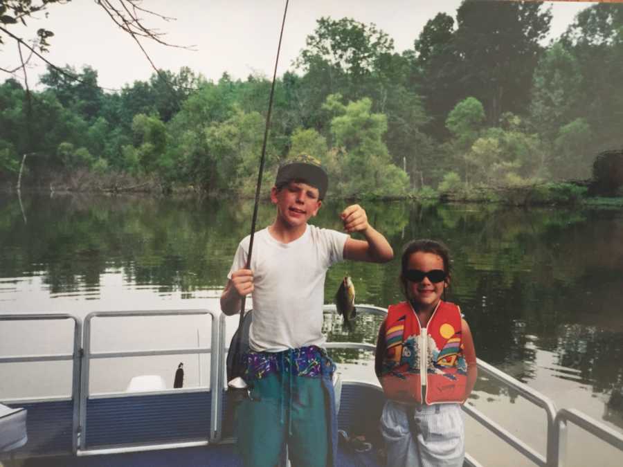 Little girl standing beside her now late brother holding up a fish when they were younger