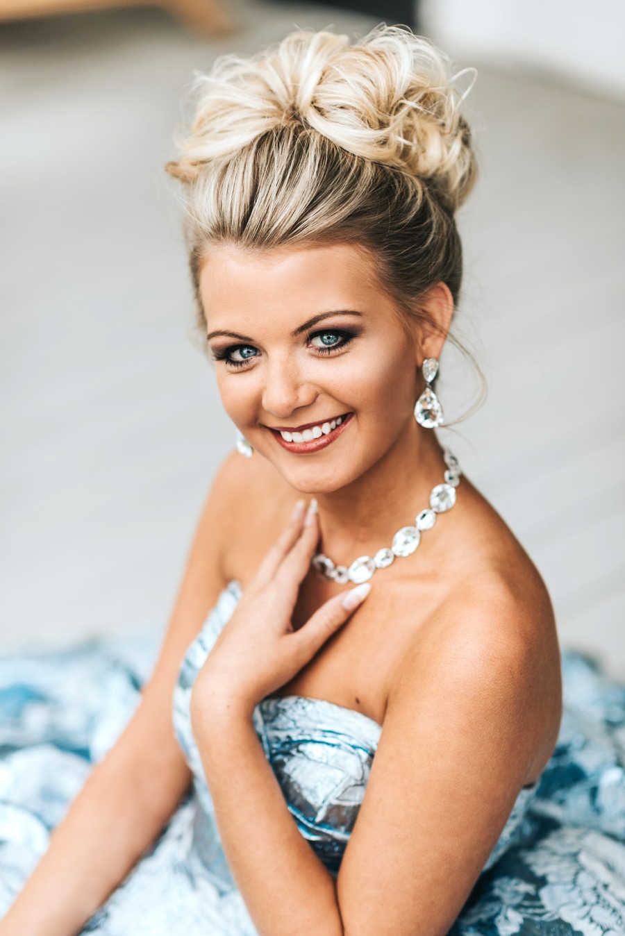 Close up of teen with focal seizures smiles in prom dress