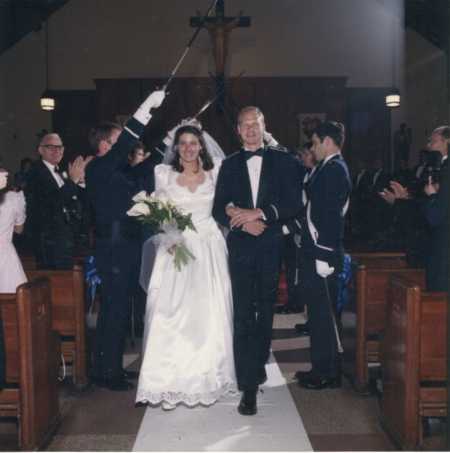 Bride walking down aisle with groom in dress her mother made for her