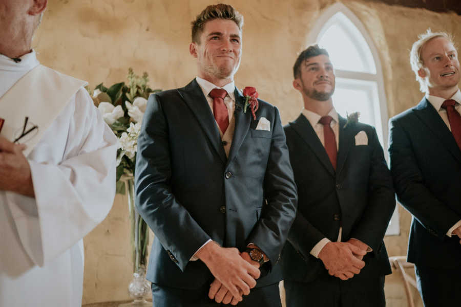 Groom whose father has cancer smiles at altar next to priest