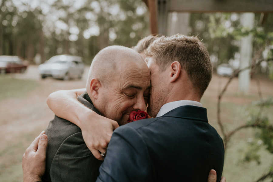 Groom and father with cancer embrace