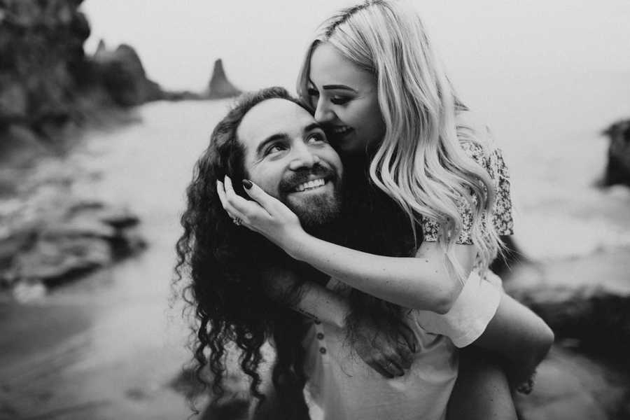 Boyfriend smiles as he gives girlfriend with Spinal Muscular Atrophy piggy back ride