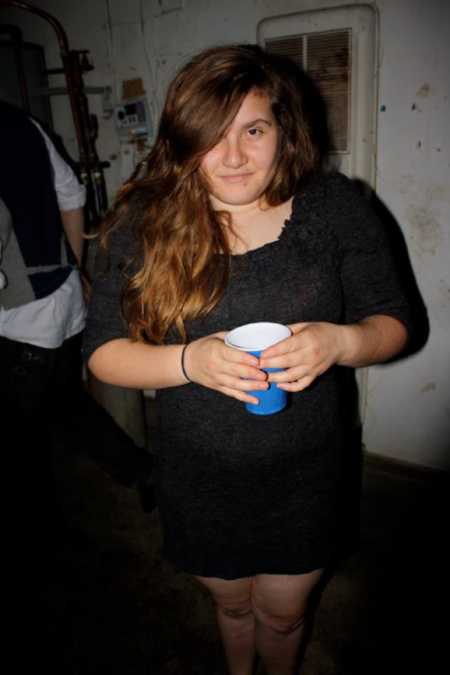 Girl at college party holding blue solo cup before losing weight