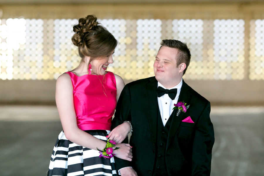 Special needs prom dates look at each other smiling arm in arm