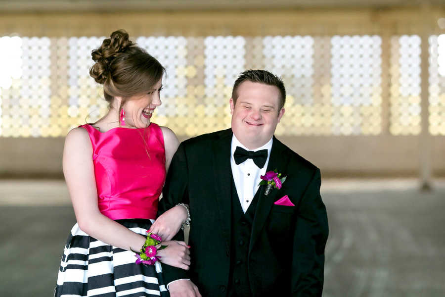 Prom dates with special needs smile arm in arm