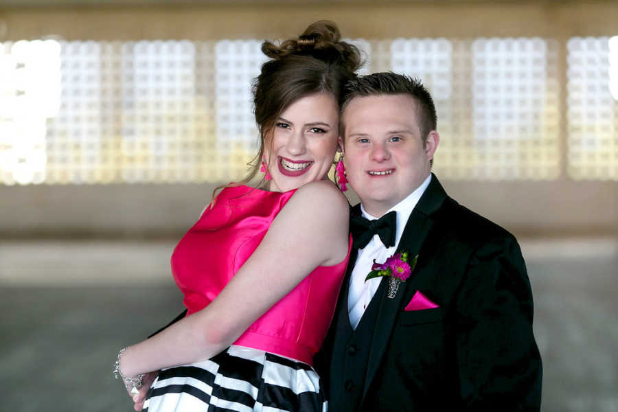 Prom dates with special needs smile arm in arm