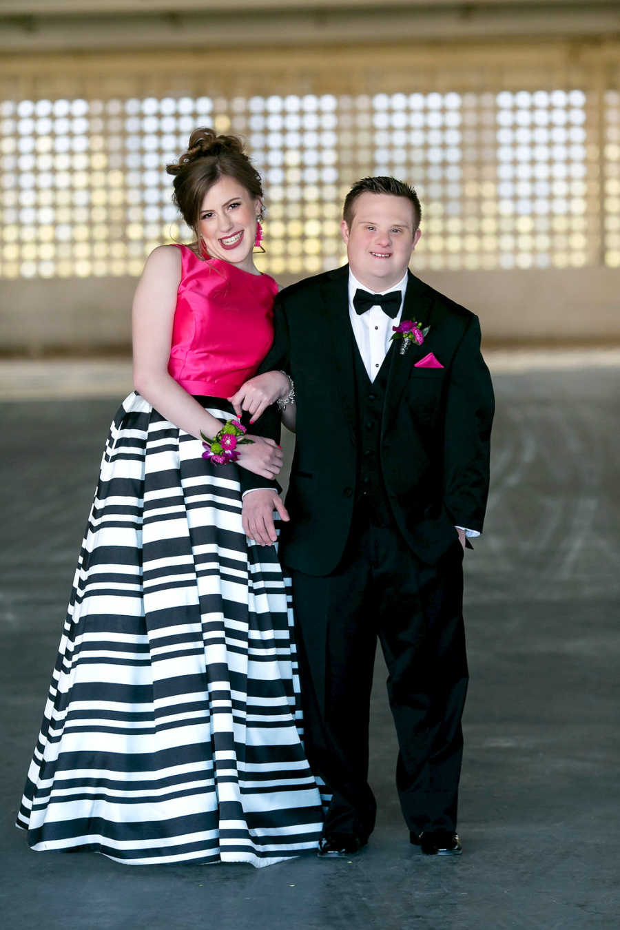Prom dates with special needs smile with boutonnieres on