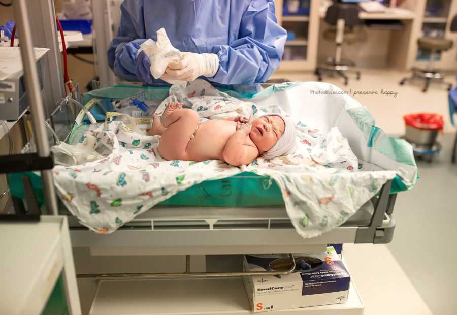 Newborn laying in cleaning station after birth 