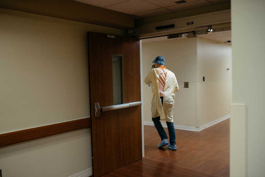 Man walking down hospital hallway to go meet his adopted child who was just born