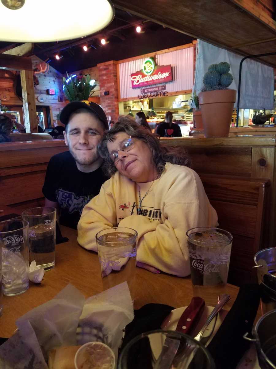 Son who donated kidney to mother sits with her in booth of restaurant
