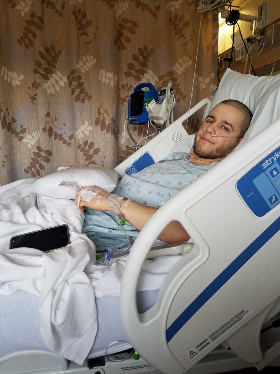 Son who is getting his kidney removed so his mother can have it laying in hospital bed