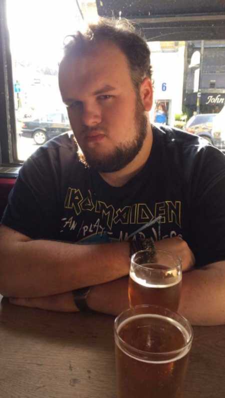 Overweight man sitting at table with beer before weight loss journey