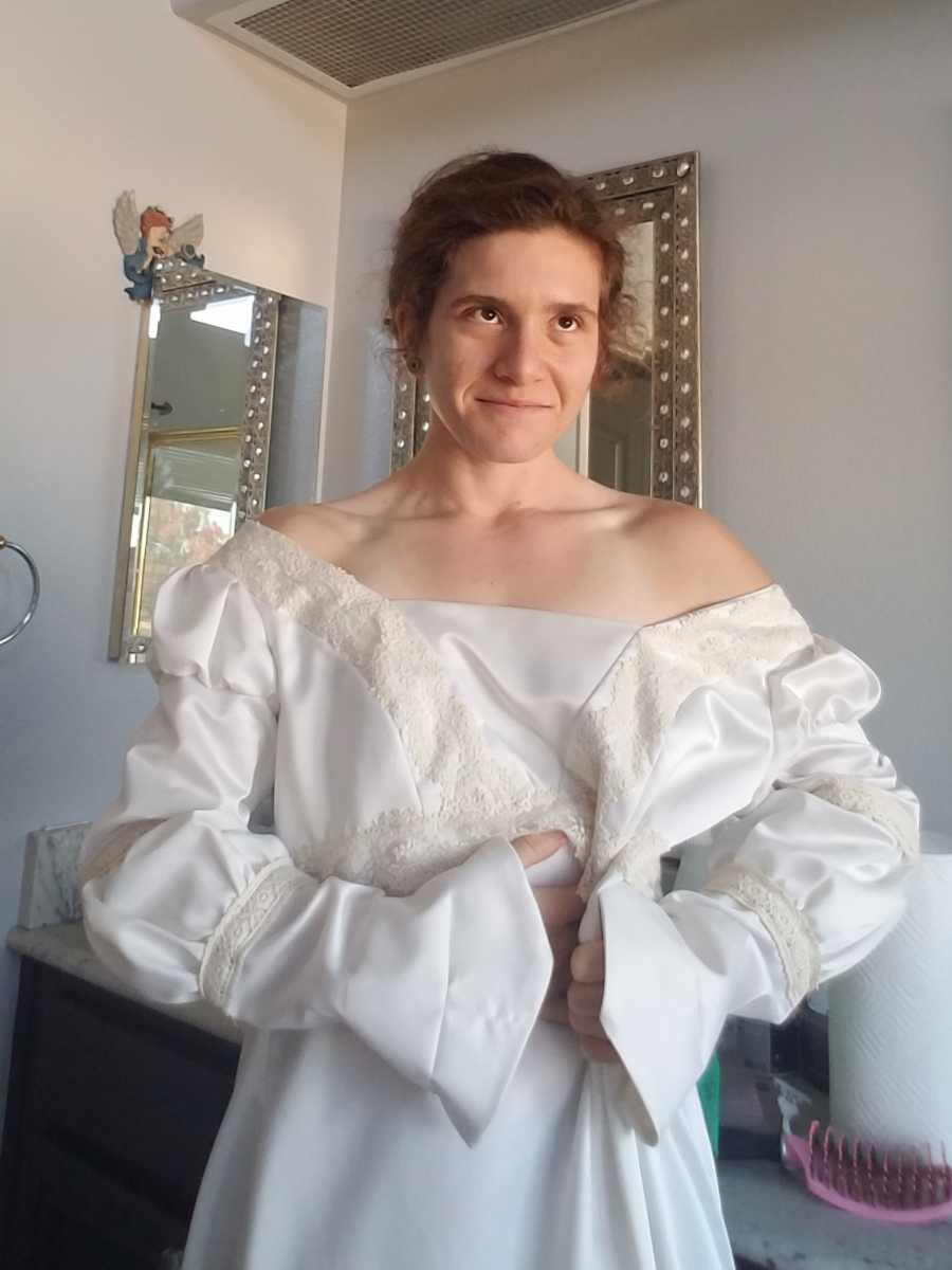 Woman who lost weight has on wedding gown that is now too big for her