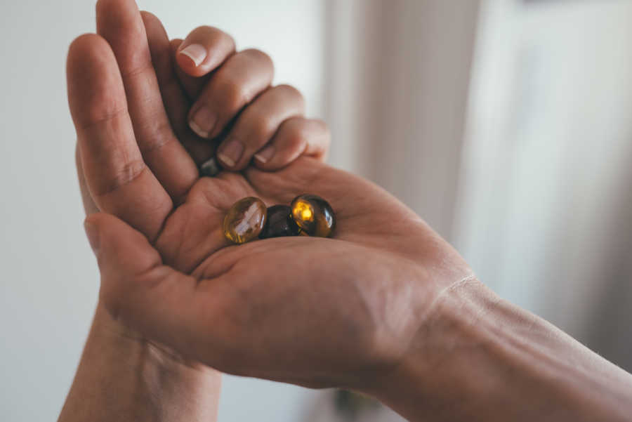Husband holding marbles symbolizing three eggs that are growing in wife after infertility issues