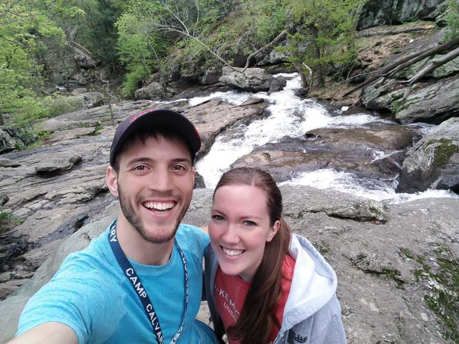 Couple who hadn't had their first kiss smiles in selfie on edge of river