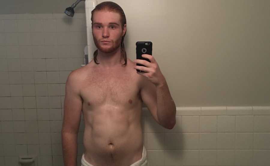 Man who suffers from depression in mirror selfie who abs are becoming defined after deciding to workout