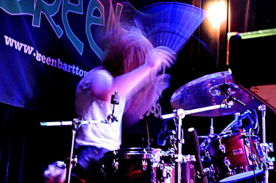 Man who turned to exercise to deal with depression playing drums at concert