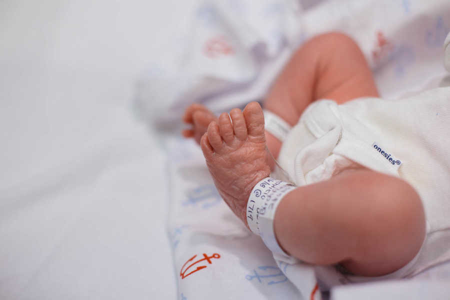 Close up of adopted newborn's ankle that has hospital bracelet around it