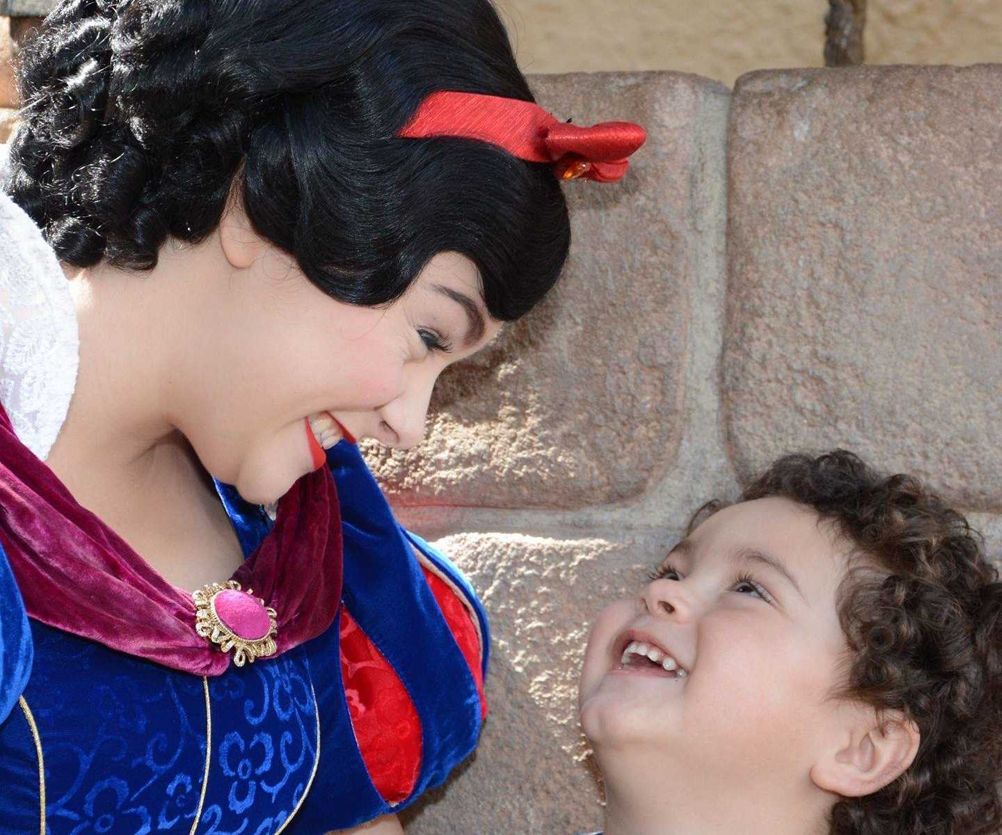 Toddler and Snow White smile at each other at Disney World