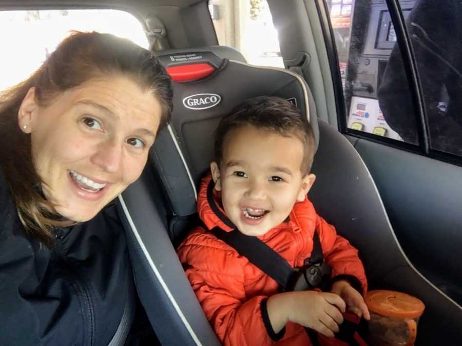 Mother smiles in selfie with son in carseat who received long term diagnosis as a baby