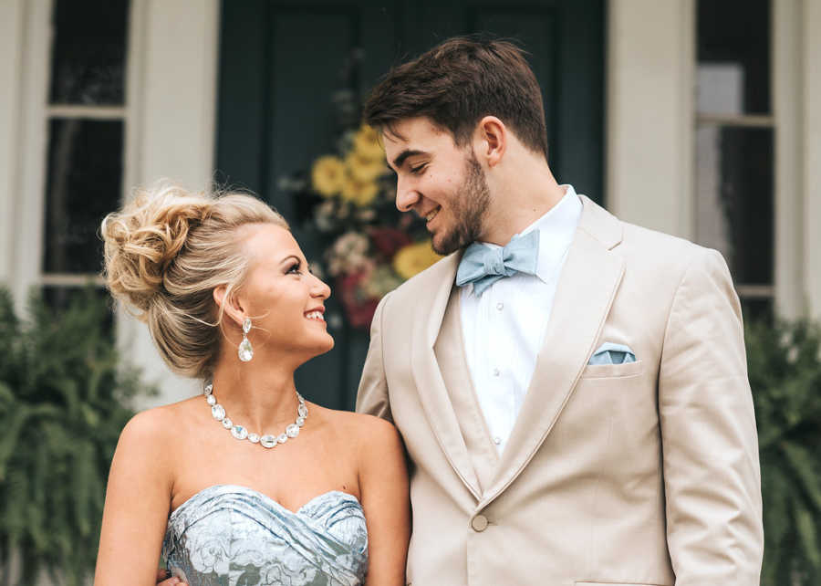Teen with focal seizures looks up at prom date as they look into each others eyes
