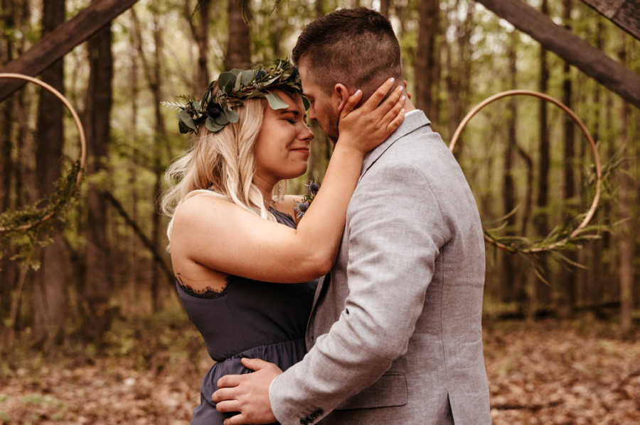 Girlfriend crying while holding face of boyfriend who just proposed