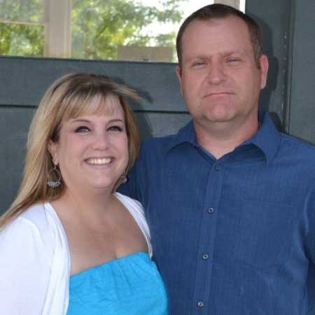 Wife smiling next to now deceased husband who she believes sends her signs