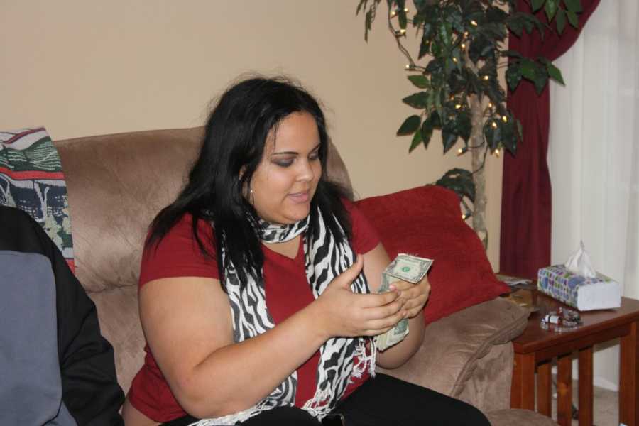 Teen nearly 300 pounds sitting on couch with cash in her hands