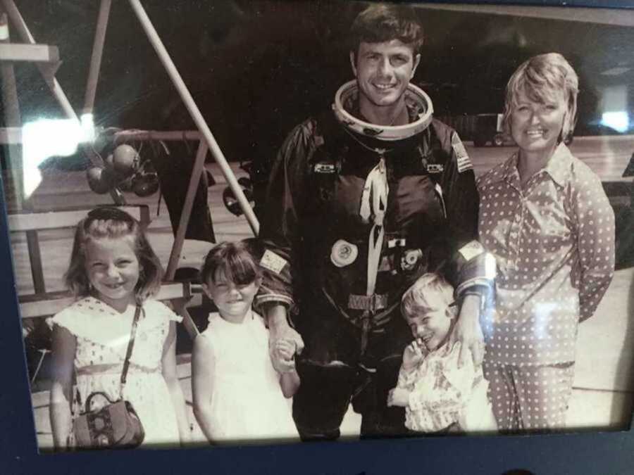 Vintage family photo of dad in spacesuit with wife and kids