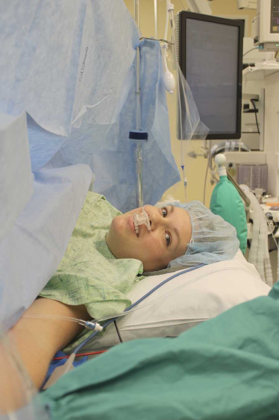 Pregnant woman lies in operating room before c-section