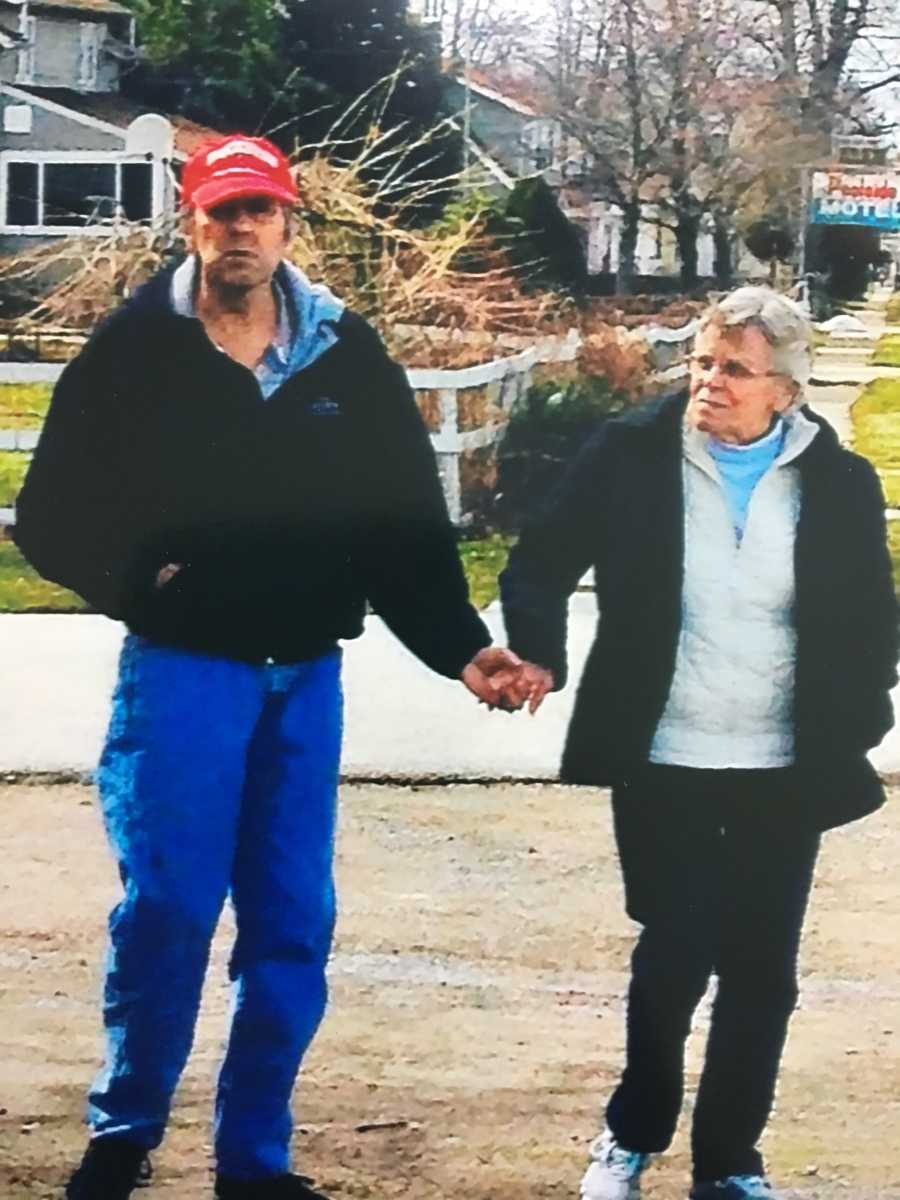 Man who will later suffer from dementia holds hands while walking with wife